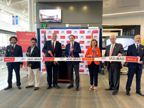 Photo of Iberia ribbon cutting in front of podium.