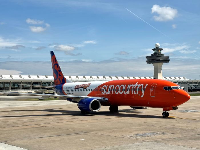 Sun Country plane in front of IAD main terminal.