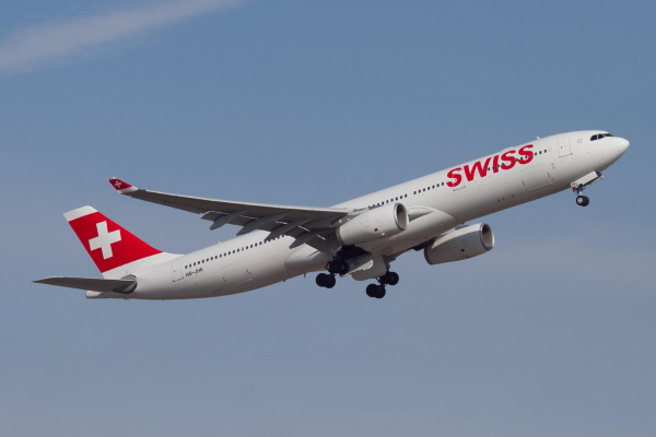 photo of swiss livery on an airplane in the sky